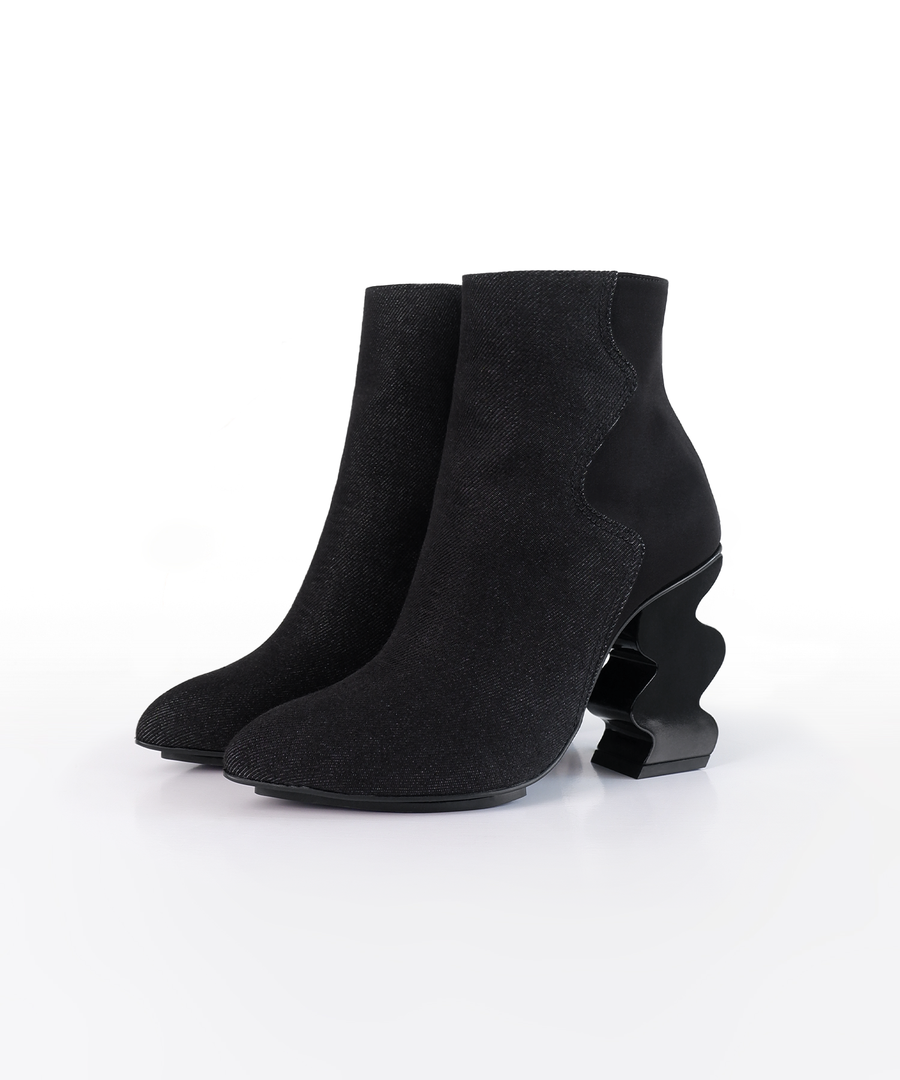 Black INES denim ankle boot with iRi's unique Dancing heel design on a white background
