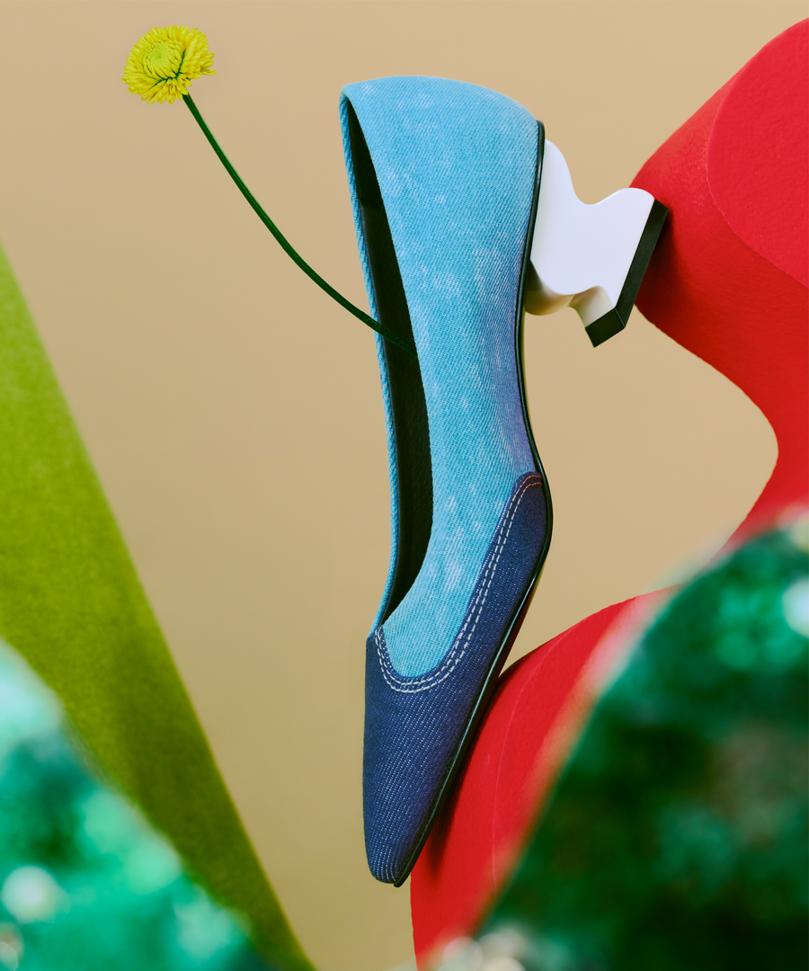 ONEL Blue Denim Pointed Toe Pumps placed on a custom made stool against a warm hazel color backdrop