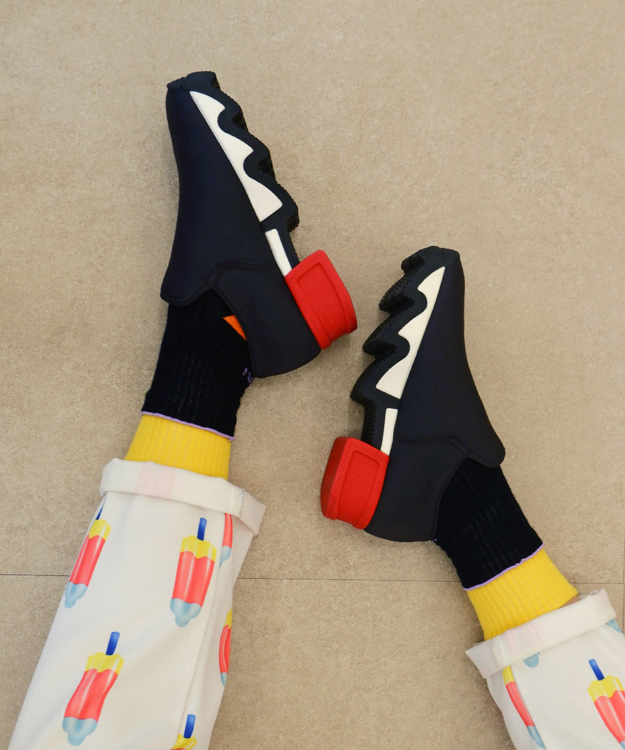 Model wearing DOUBLE DECK Black Socks with WES Black Red Low Top Sneaker