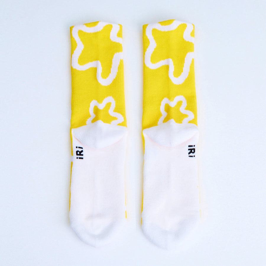 Yellow-white socks with iconic iRi abstract patterns on a white background