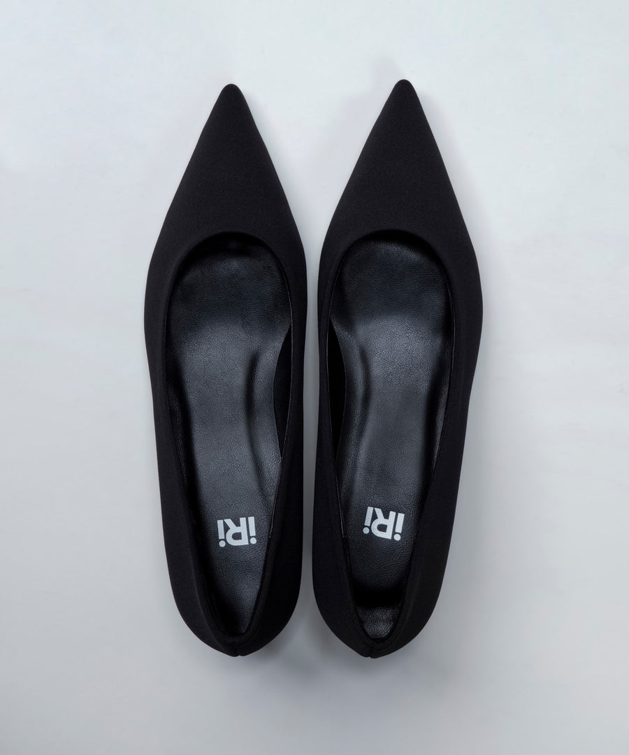 Pair of black pointed-toe shoes on a light gray background