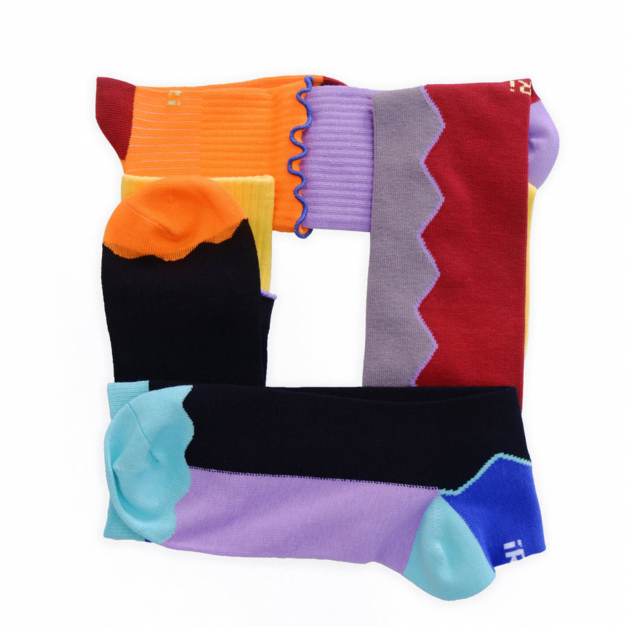 A model wearing popsicle pants, styled with iRi DOUBLE DECK Black Multi Crew Sock